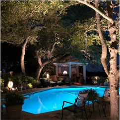 Swimming pool with accent lighting in backyard