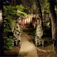 Illuminated garden pathway with trees