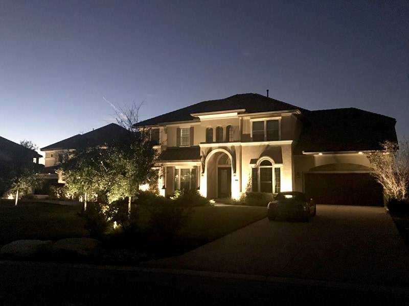 Outdoor lighting lights up the face of a South Texas home