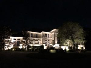 outdoor lighting shine upon a huge beautiful home