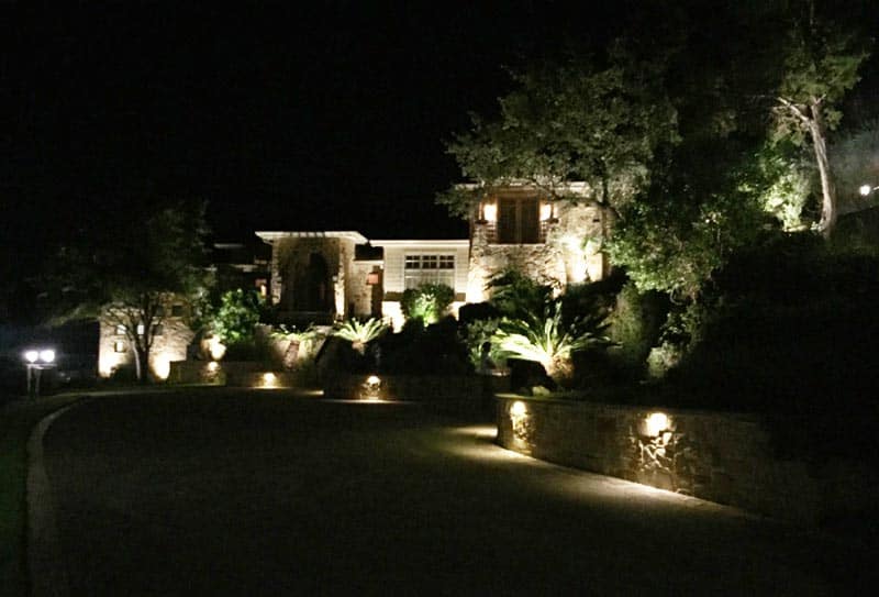 beautiful front yard lit up with lights