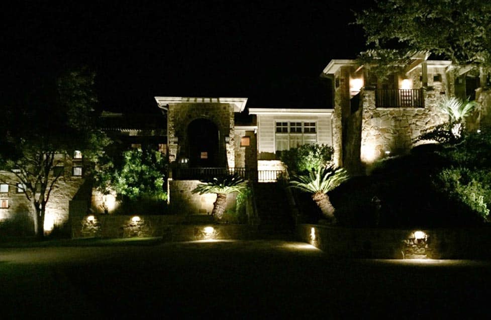 beautiful front yard lit up with lights