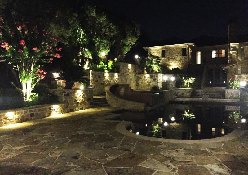 A gorgeous outdoor lighting set up around a pool.