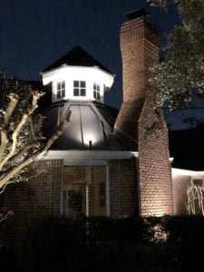 a light pointed to the top of a house
