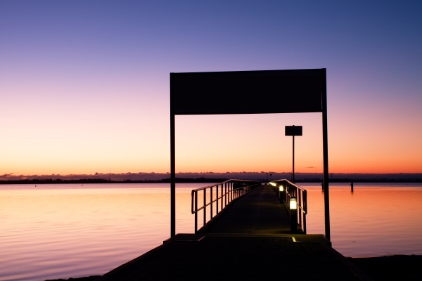 A boat dock at sunset.